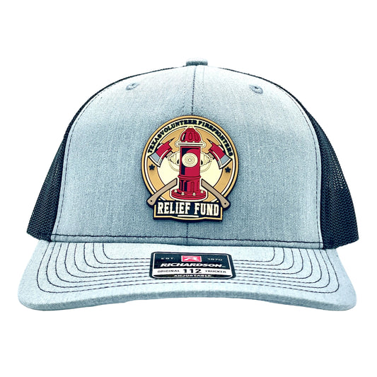 A light gray and black trucker hat featuring a circular front patch with a red fire hydrant and crossed axes labeled 'Texas Volunteer Firefighters Relief Fund'.