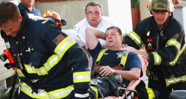 Injured Firefighter Being Carried On A Stretcher.