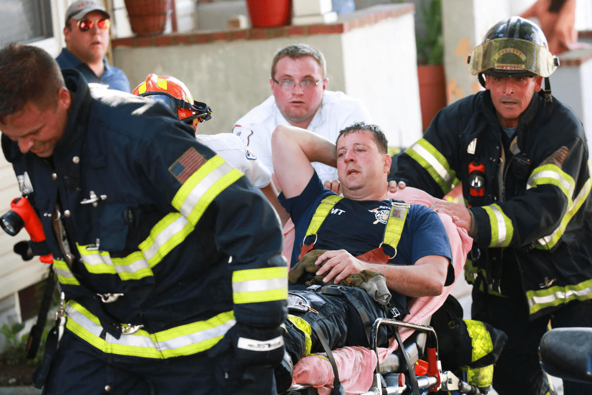 Injured firefighter being carried on a stretcher.